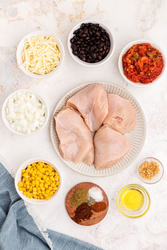 Ingredients needed to make Cowboy chicken, measured out into small white bowls on a marble table.