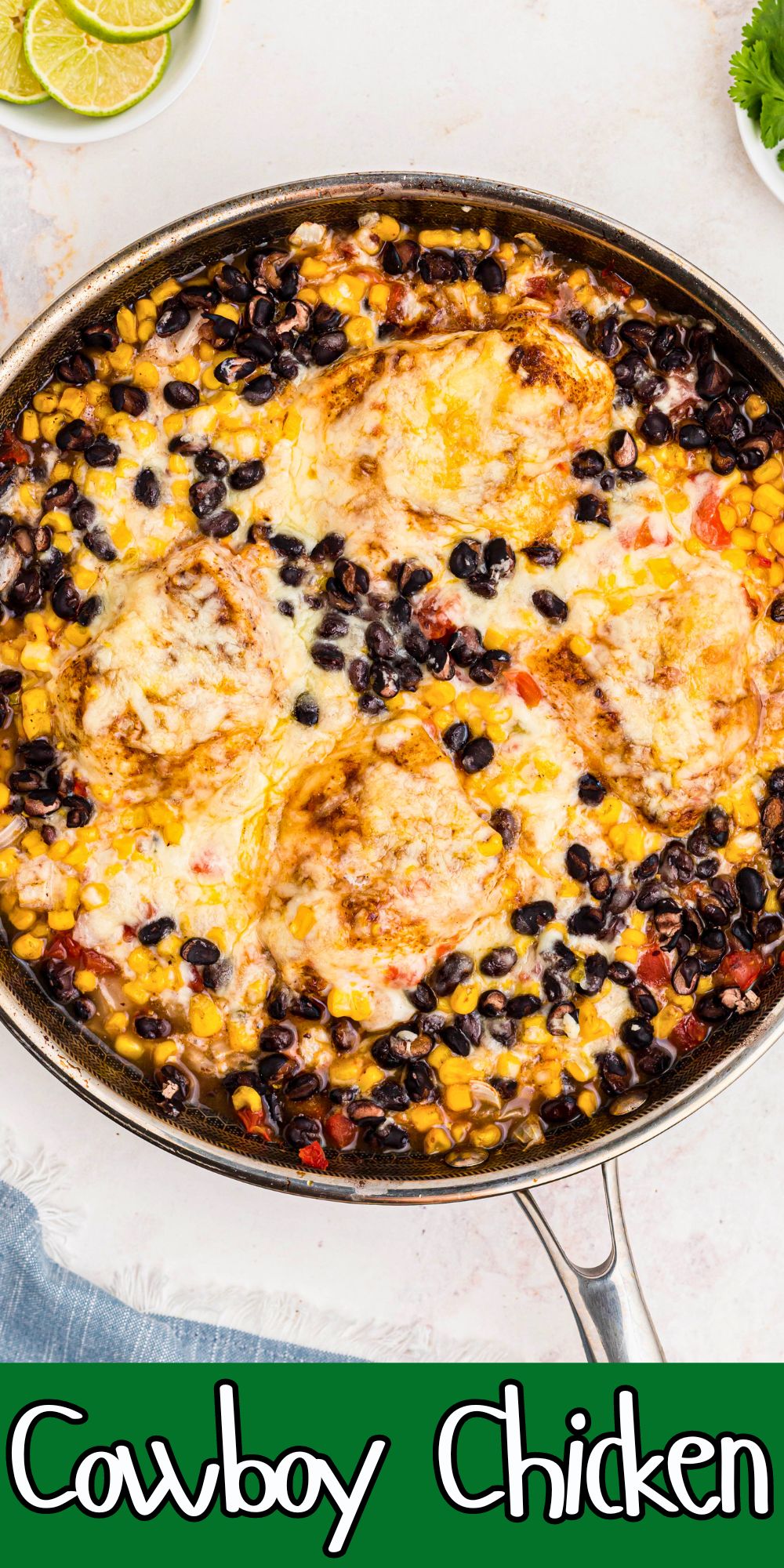 Chicken covered in cheese, beans, and veggies, in a large skillet.