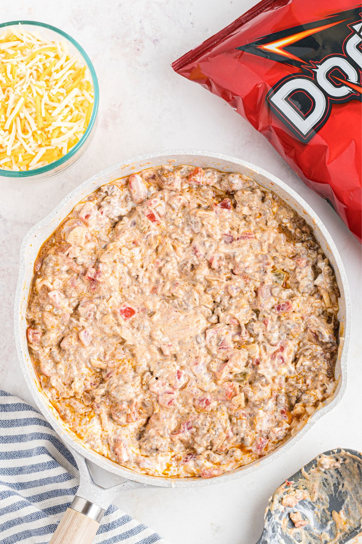 Meat, sour cream and cheese, combined in a skillet.