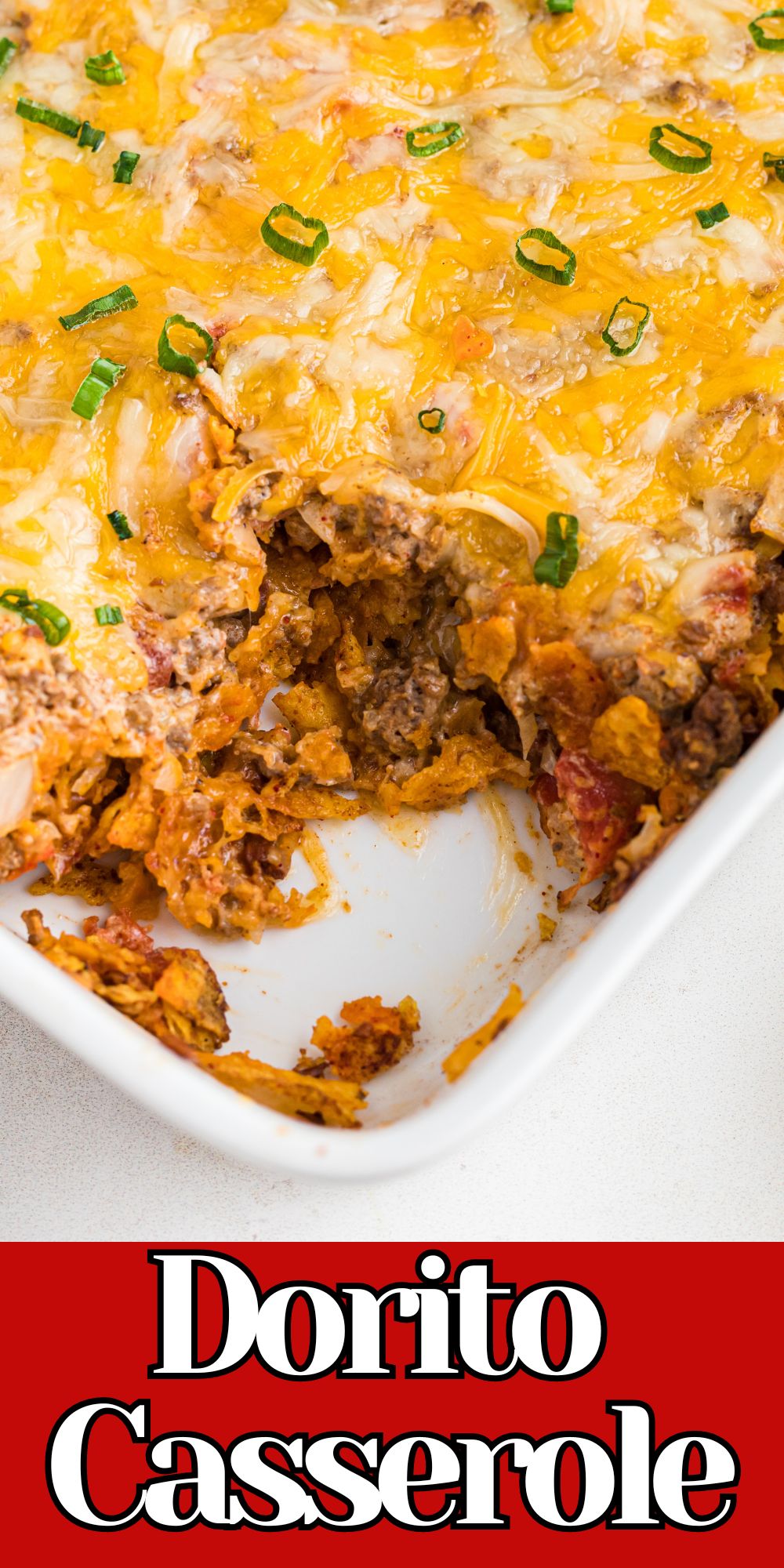 Ground beef and Doritos in a white casserole dish.