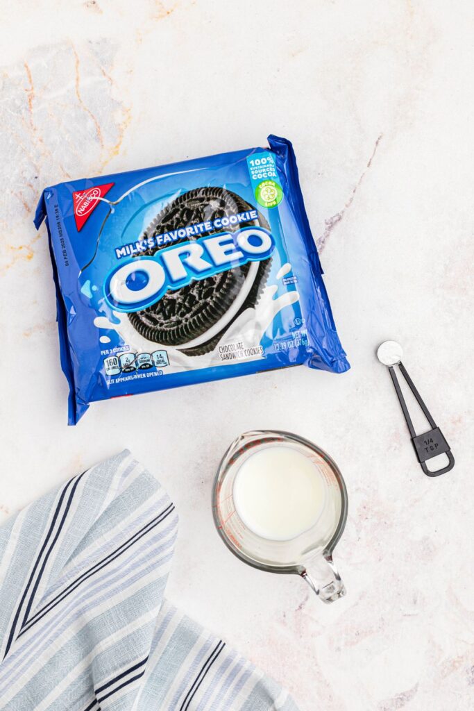 Oreos, milk, and baking powder measured out on the marble table. 