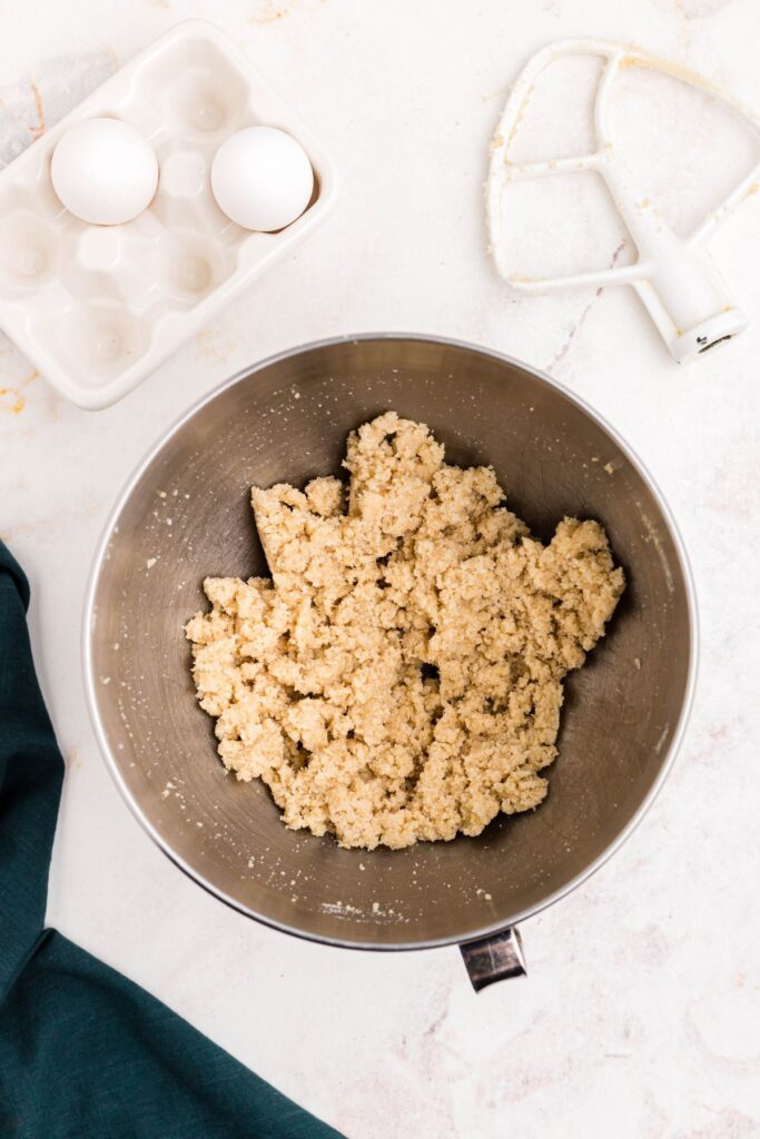 Sugars and butter being mixed in a  bowl. 