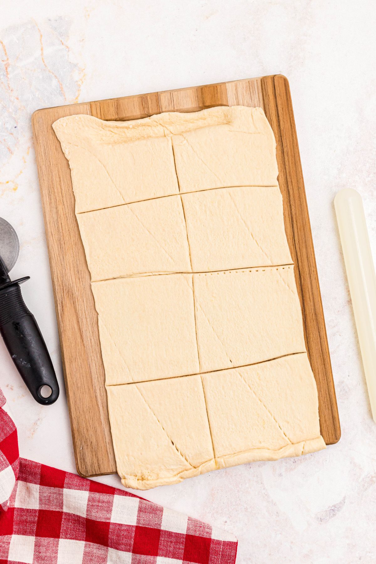 Crescent dough rolled out and cut into 8 squares.