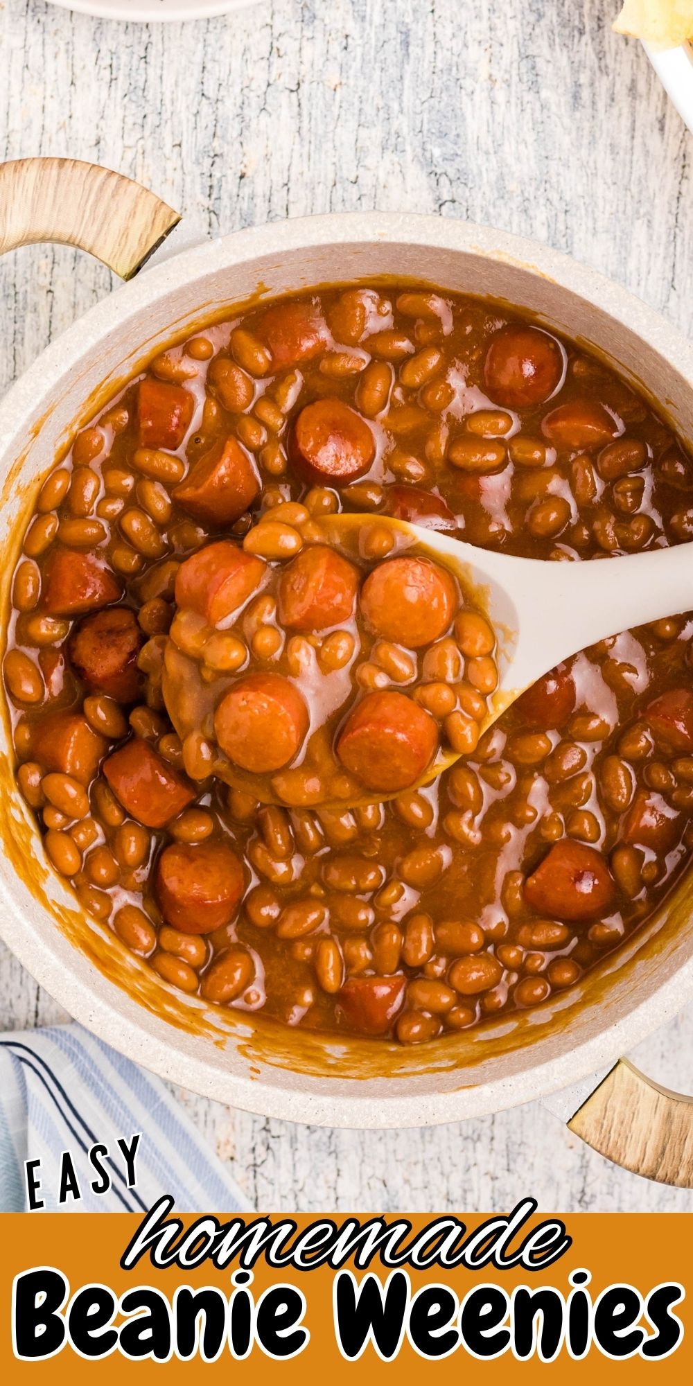 Close up photo of beans and weenies in a saucepan with a large spoon in the center, over the title.