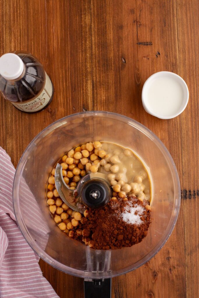 Hummus ingredients in the food processor bowl before being mixed together. 