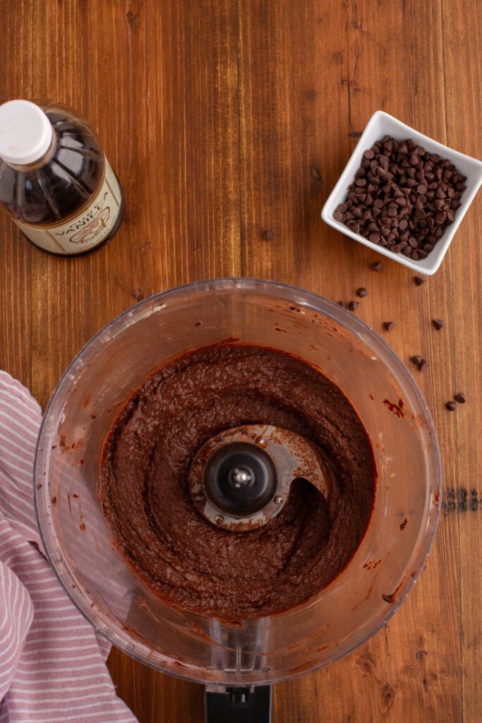 Creamy chocolate hummus after being mixed in the food processor bowl. 