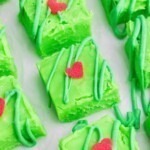 Bright green squares of fudge cut on a white table.