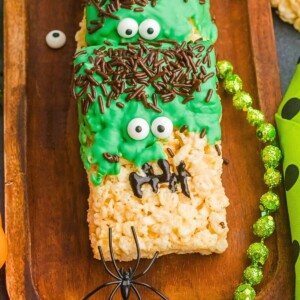 Decorated Frankenstein rice krispies treats on a wooden board.