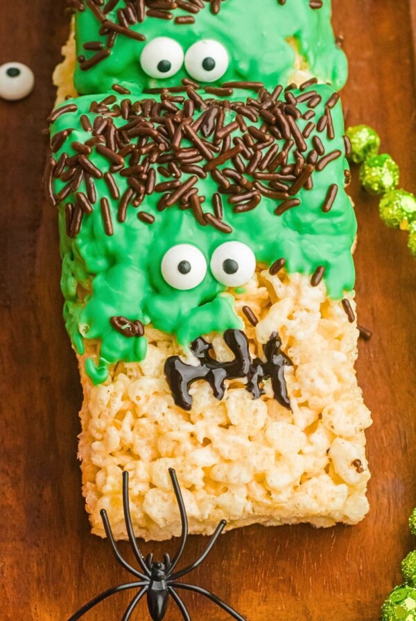 Decorated Frankenstein rice krispies treats on a wooden board.