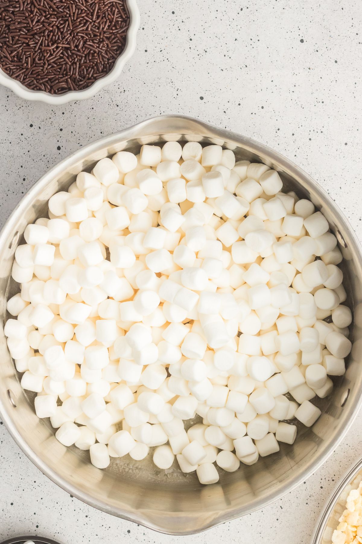 Marshmallows added to a large pot with melted butter. 