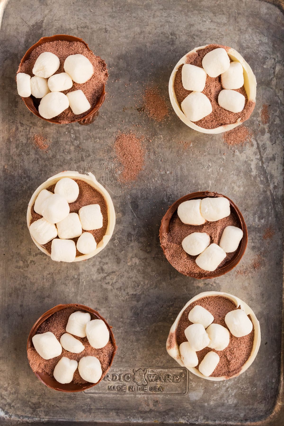Cocoa bombs spheres filled with cocoa powder and mini marshmallows.