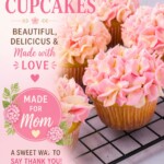 Pink and white frosted cupcakes on a white rectangle plate.