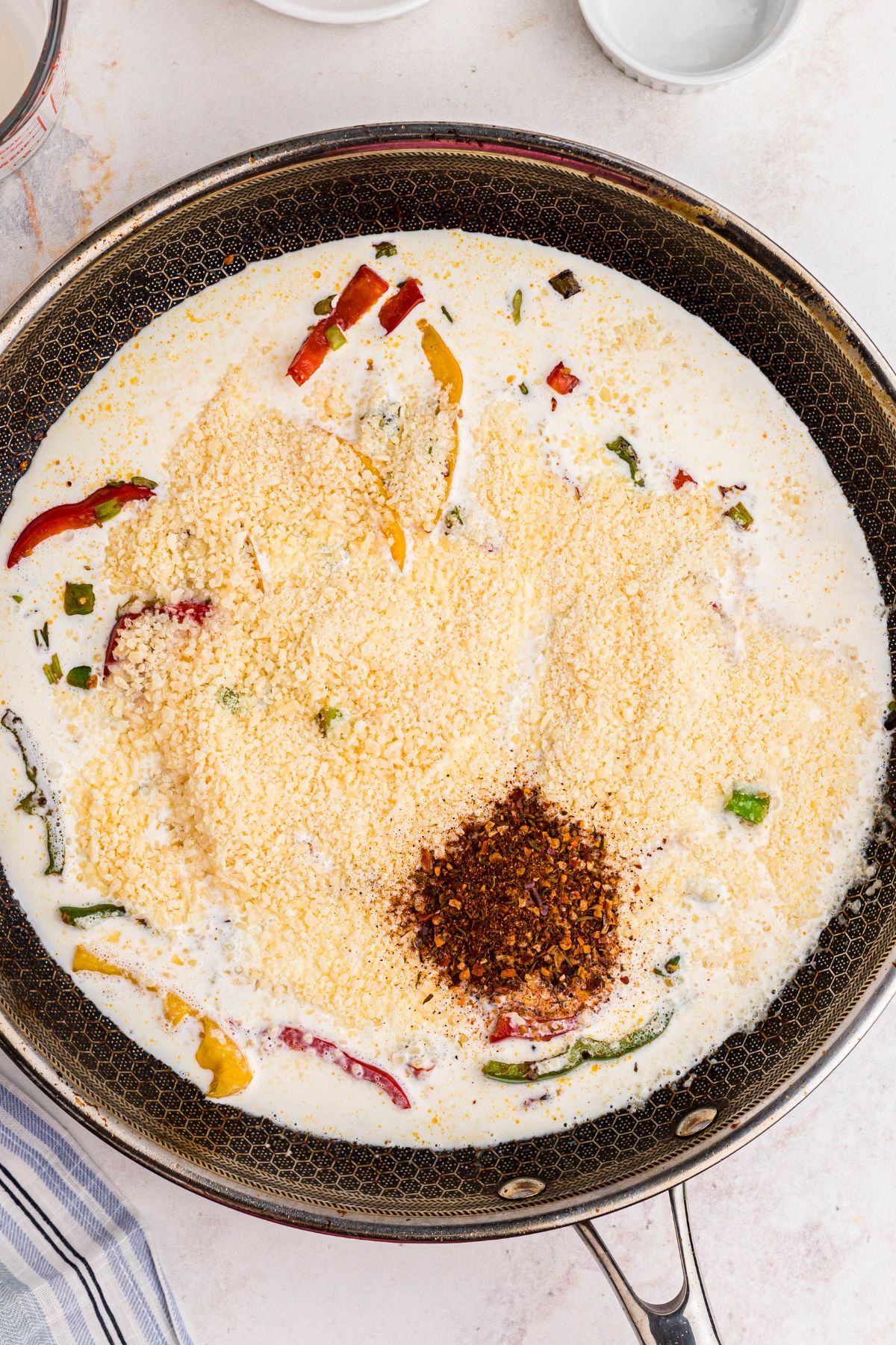Ingredients needed to make rasta pasta in a large skillet before cooking.