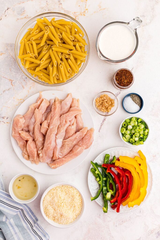 Ingredients needed to make rasta pasta  measured out on a marble table. 