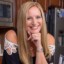 Photo of Becky in the kitchen with cupcakes in front on the counter