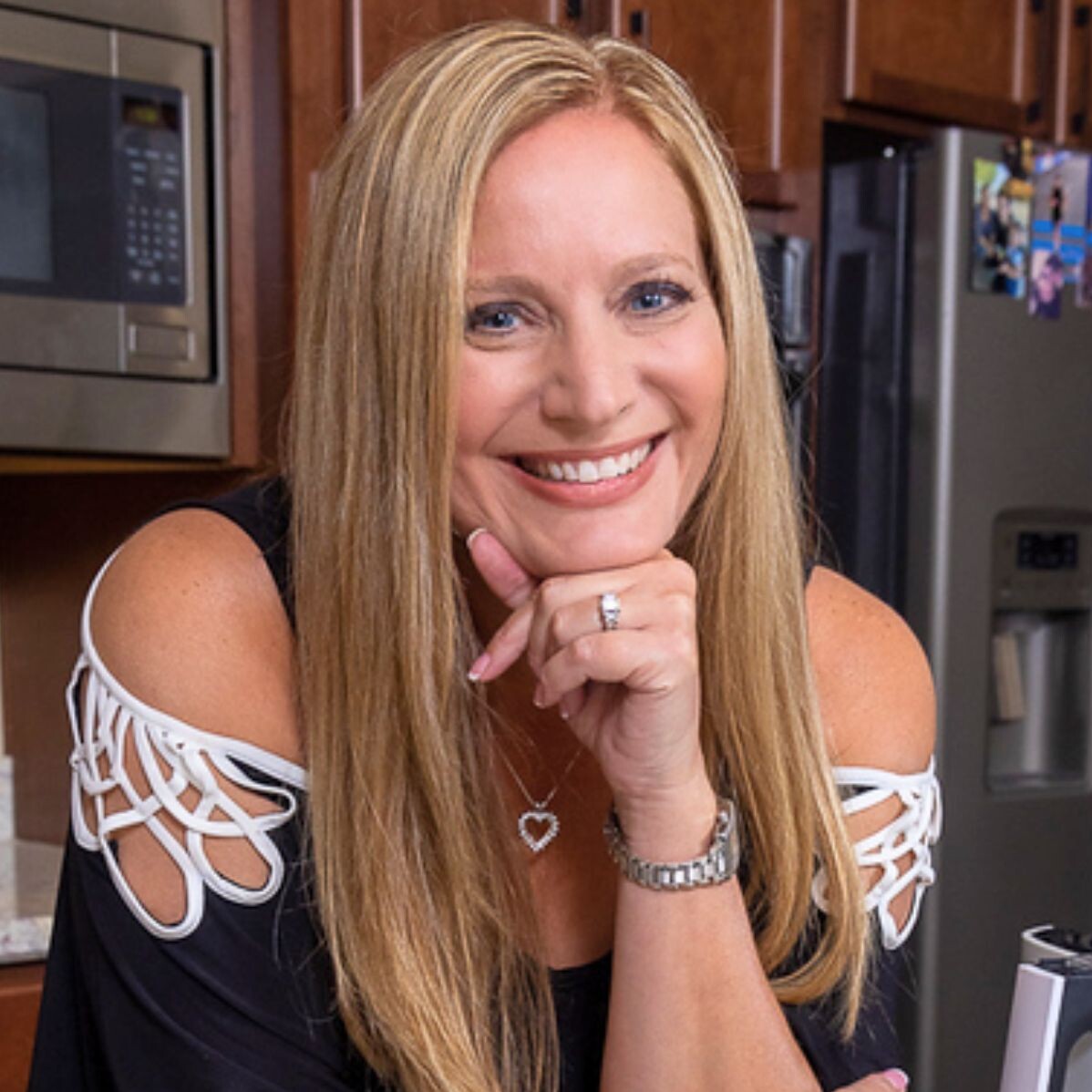 Photo of Becky in the kitchen with cupcakes in front on the counter