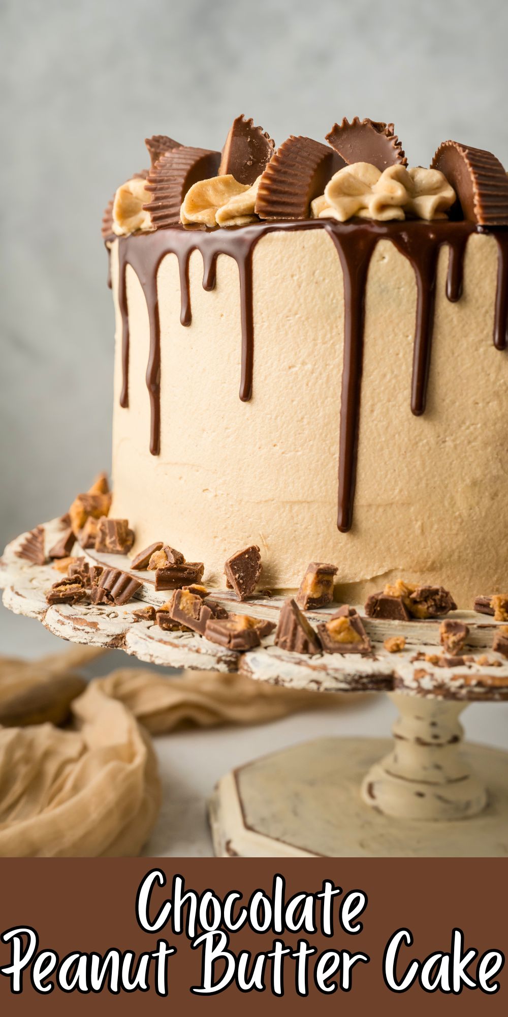 Chocolate cake covered in peanut butter frosting with a chocolate ganache drizzle down the sides.