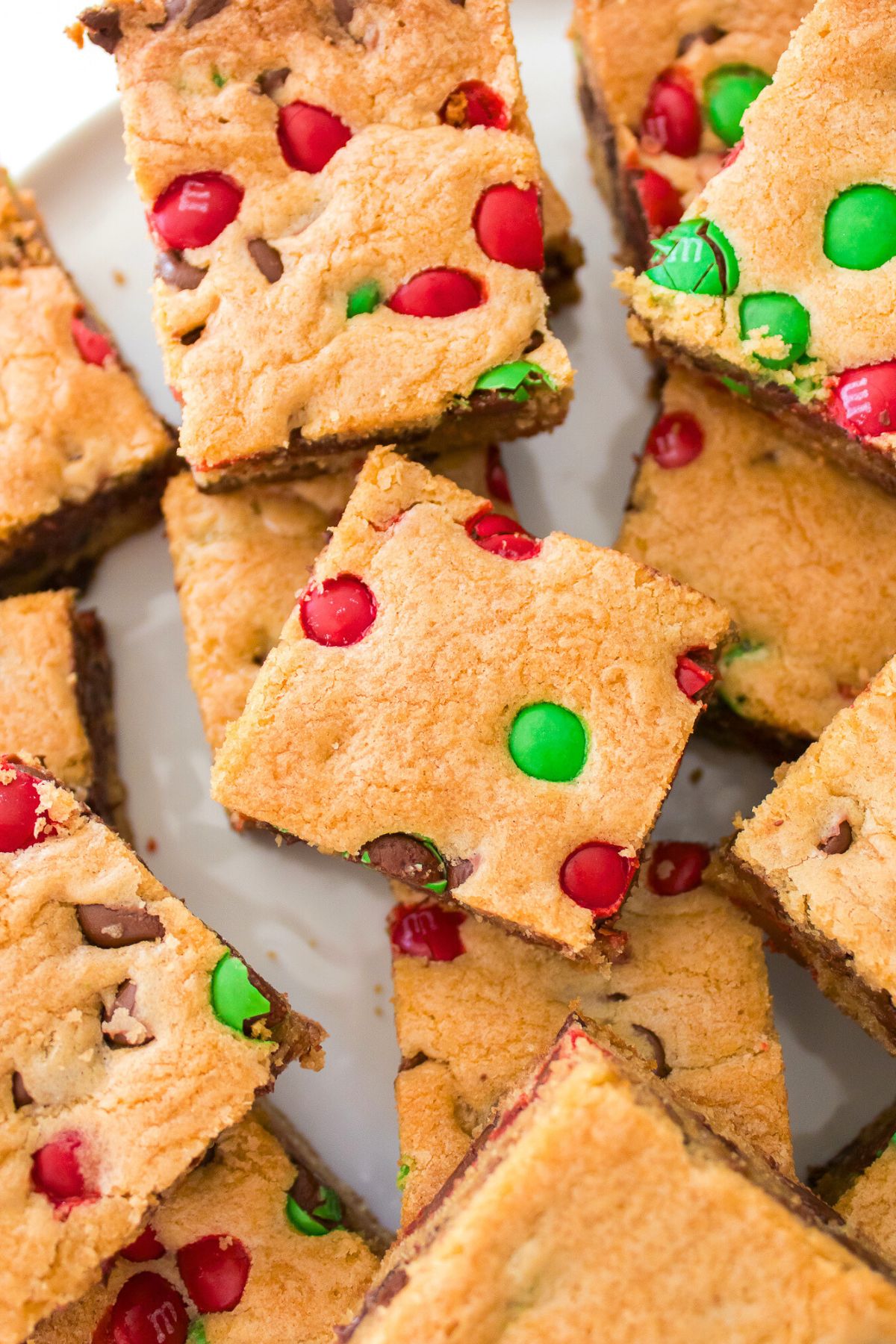 Golden brown cookie bars cut into squares, stacked on a table. 