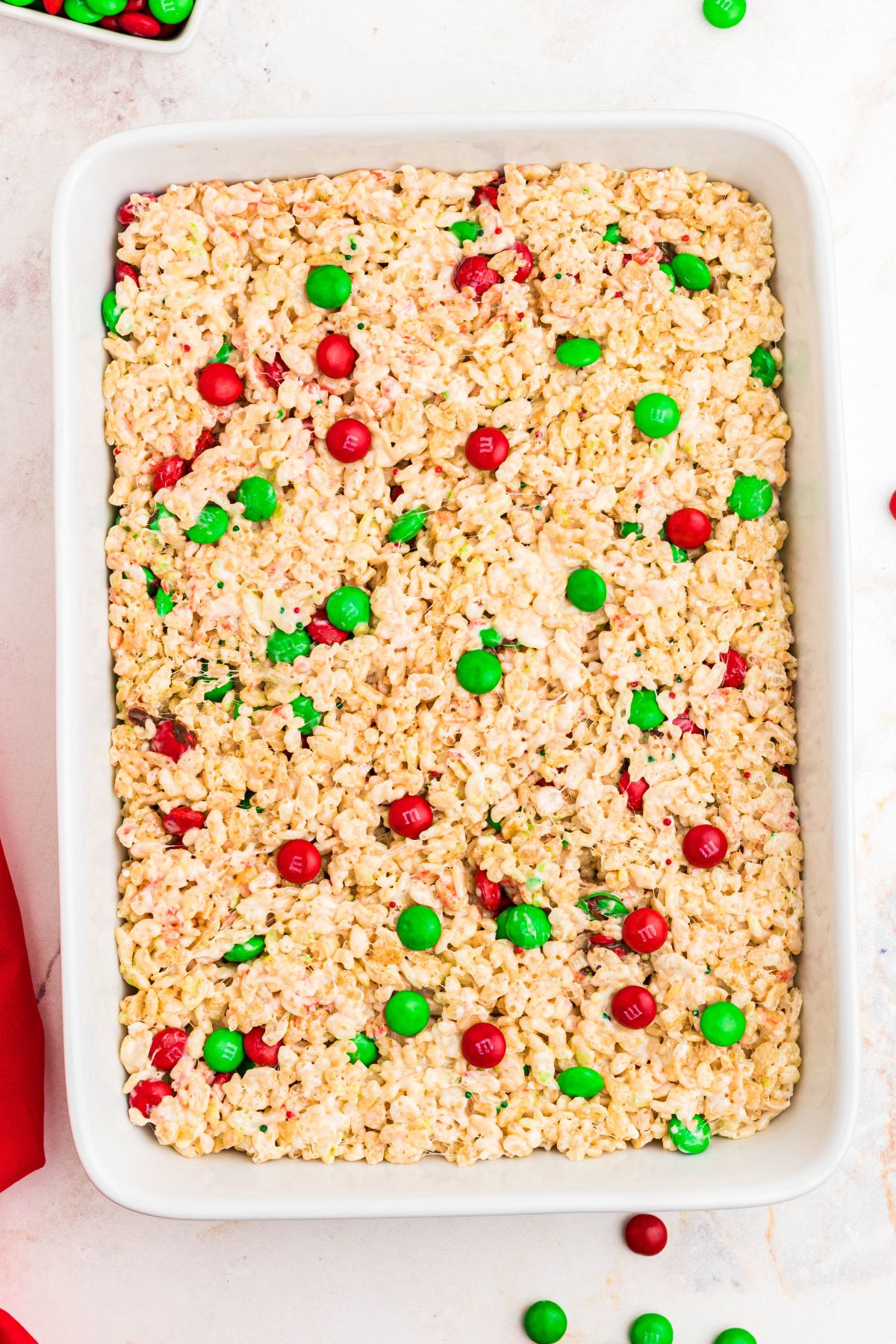 rice krispie treats with red and green chocolate candies mixed in. 