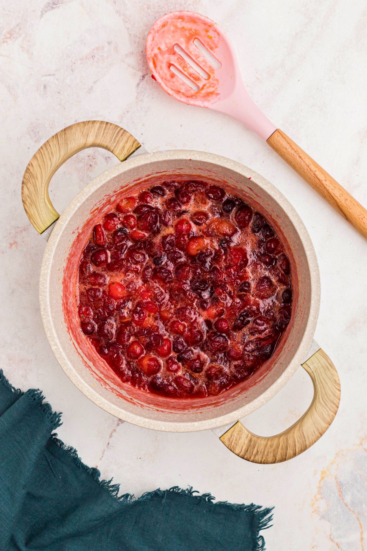 Cranberries, sugar, and juice, simmered together making a cranberry orange sauce. 