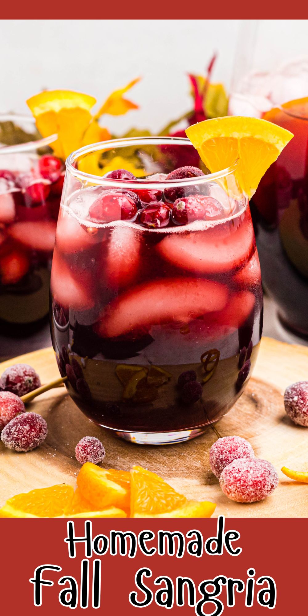 Sangria in a clear stemless glass with orange slice as a garnish.