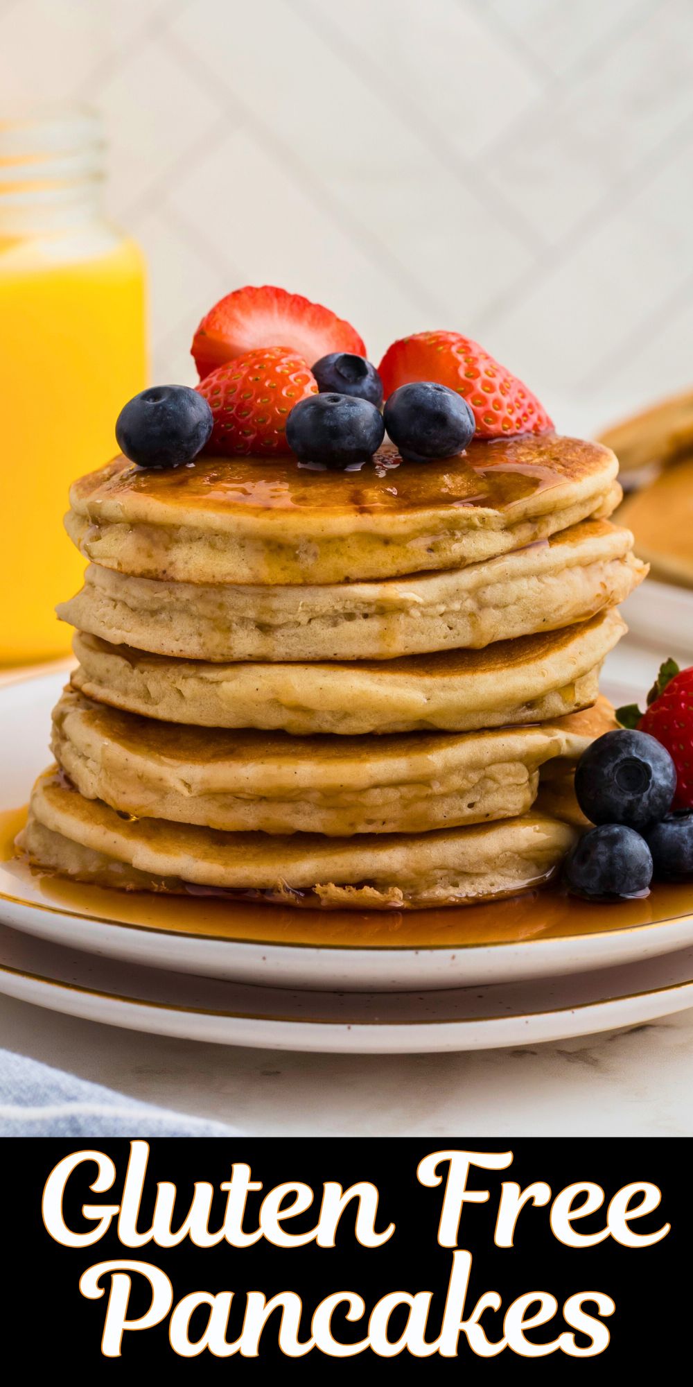 Golden gluten free pancakes stacked on a white plate.