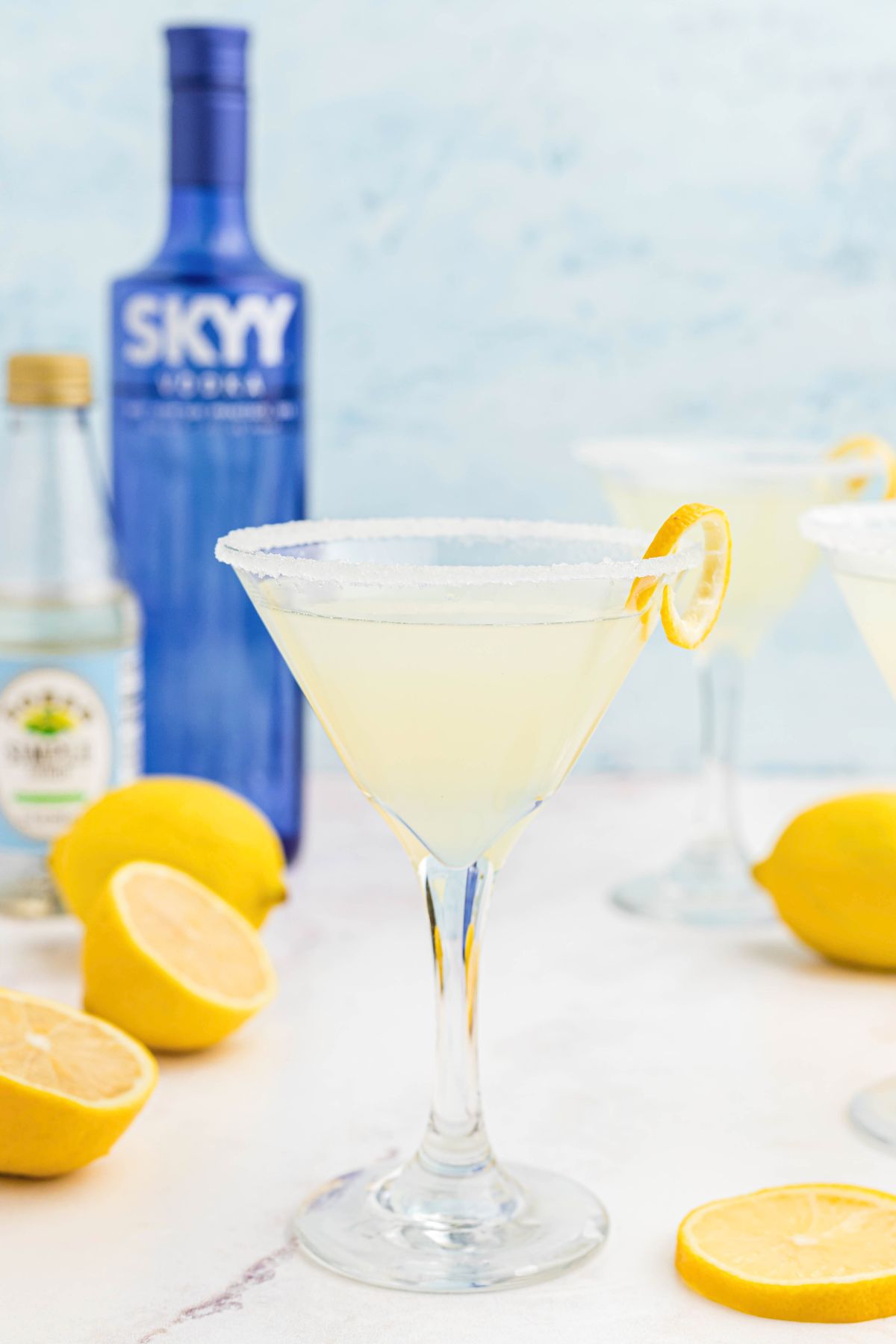 Lemon drop martini in a martini glass with a lemon curl for garnish.