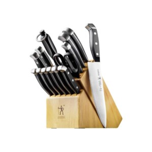 Knife set with black handles in a wood block.