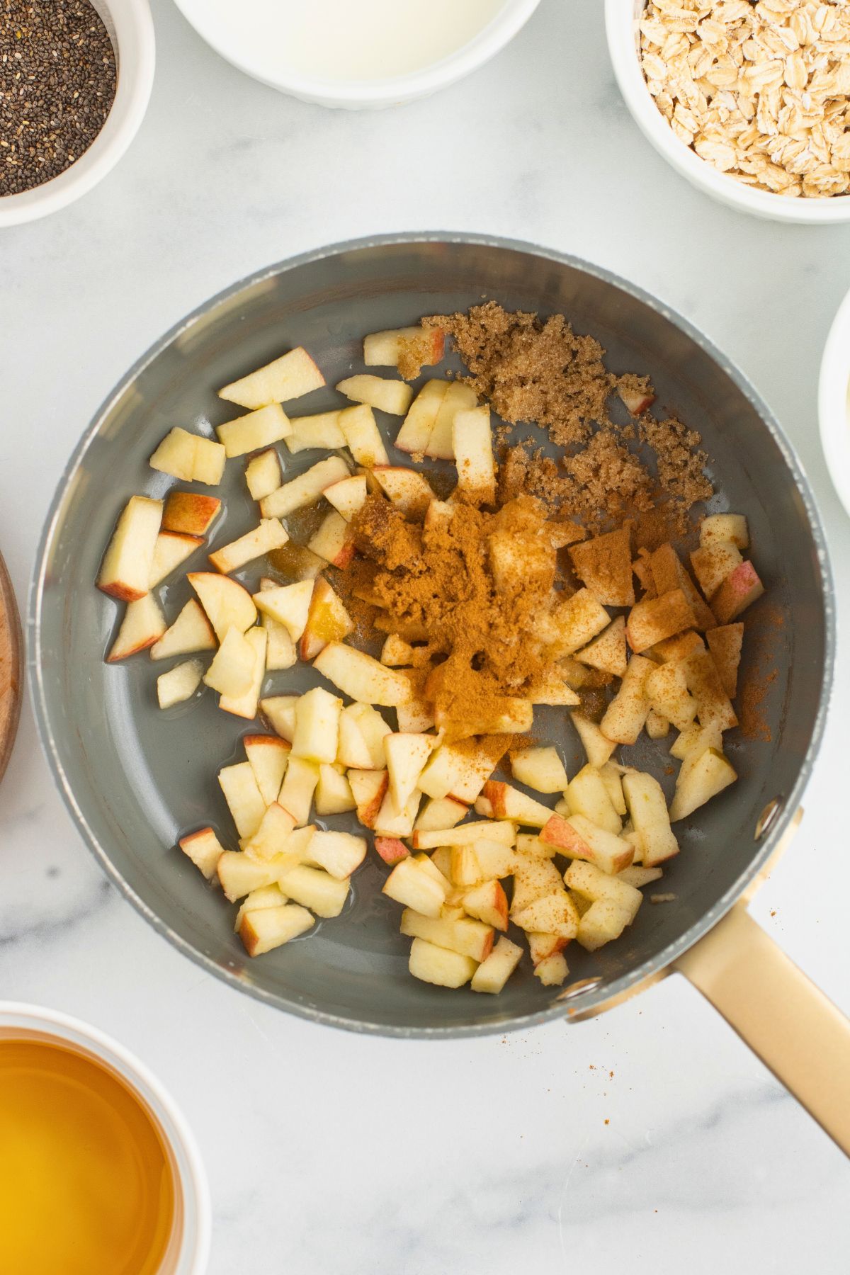 Apples and spices in a saucepan before being cooked to soften. 