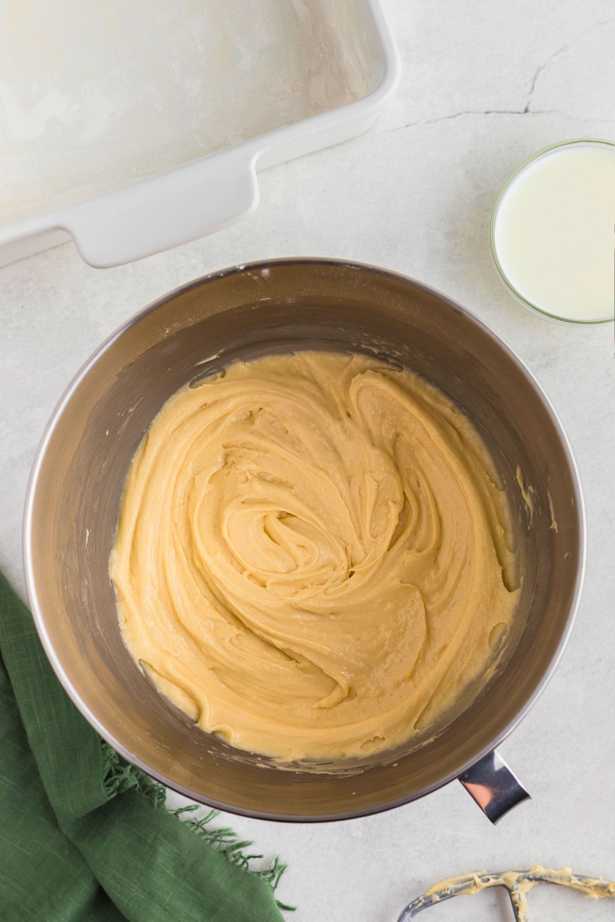 Butter cake batter mixed in a silver bowl.