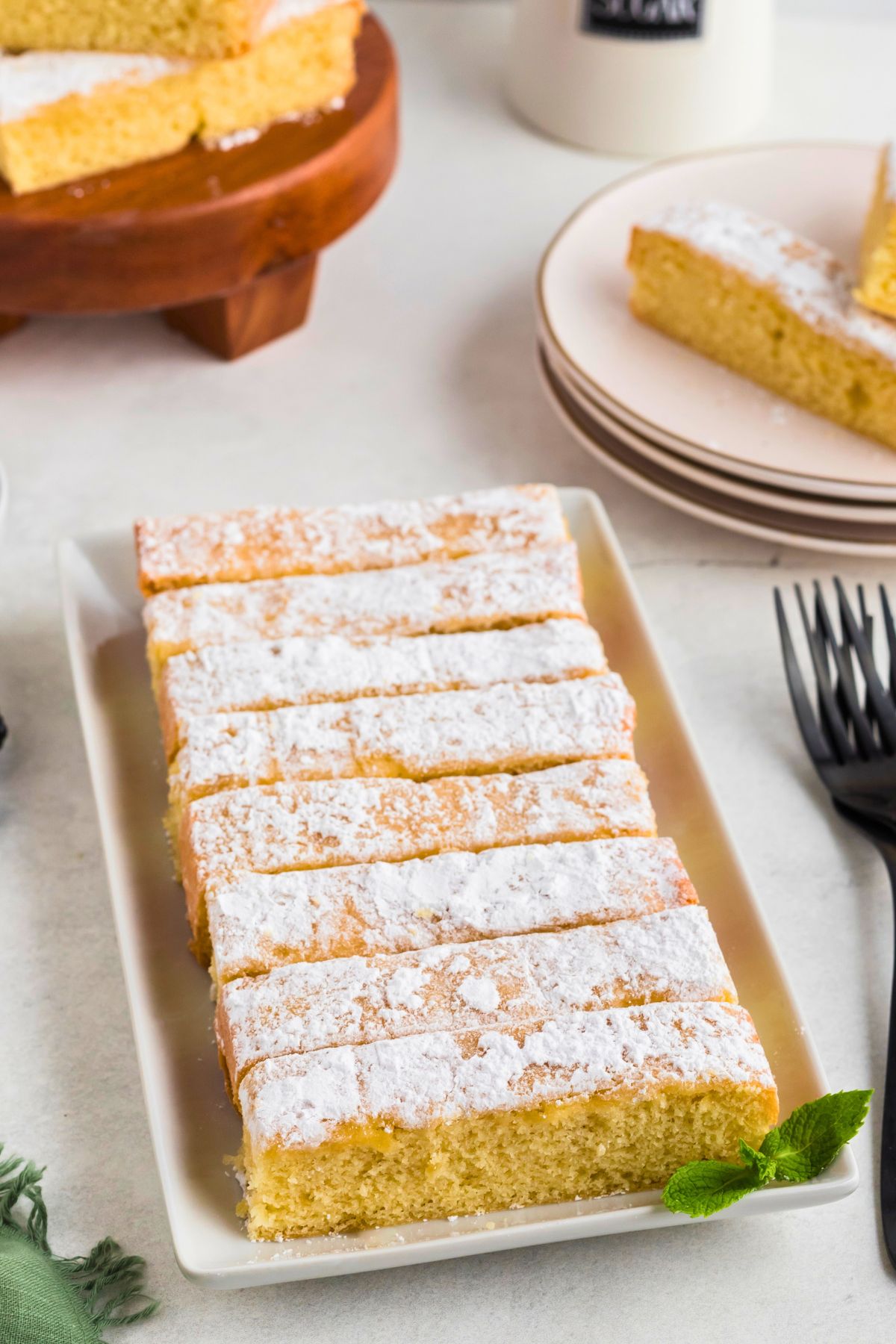 Golden buttery cake slices on a rectangle serving platter. 