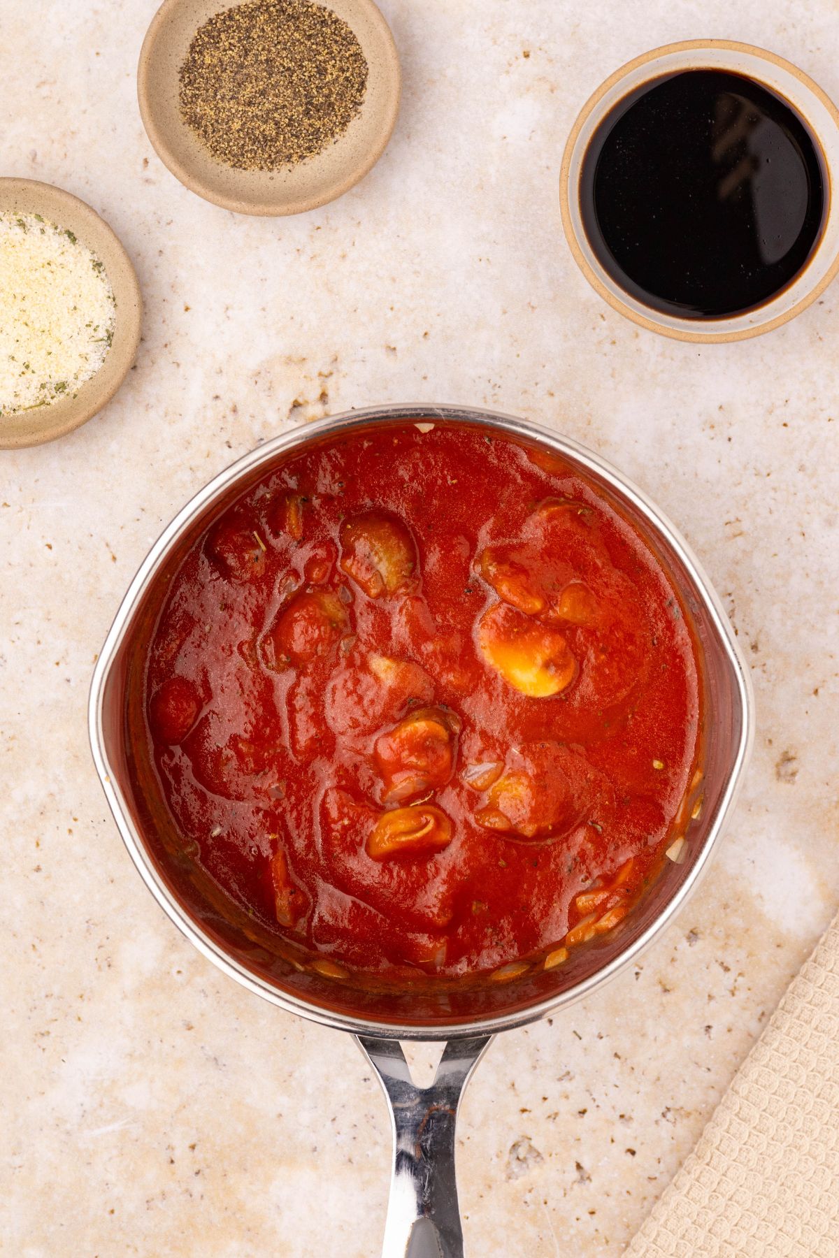 Marinara sauce with mushrooms, onions, and seasonings, in a small saucepan. 