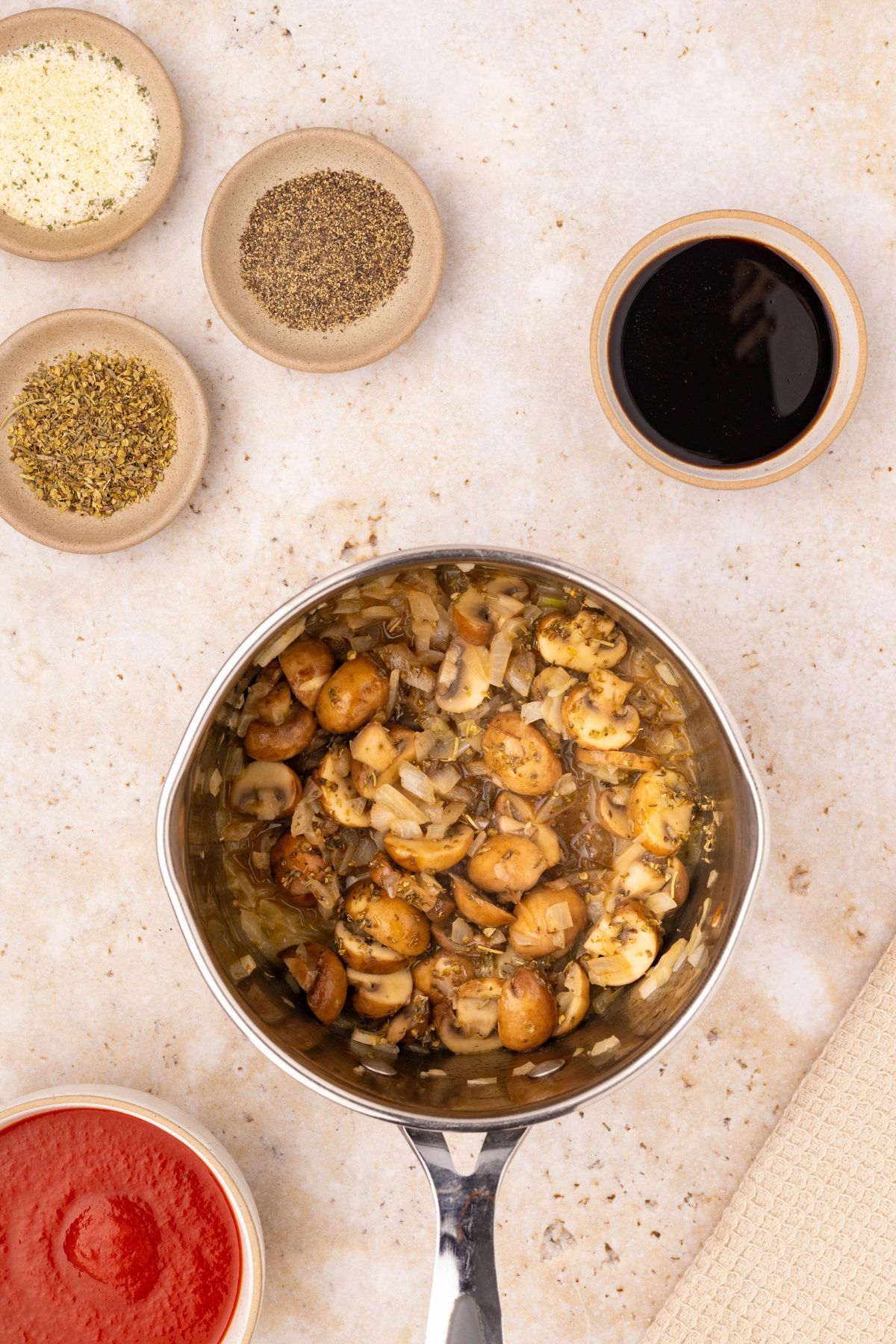 Diced mushrooms and onions in a small saucepan.