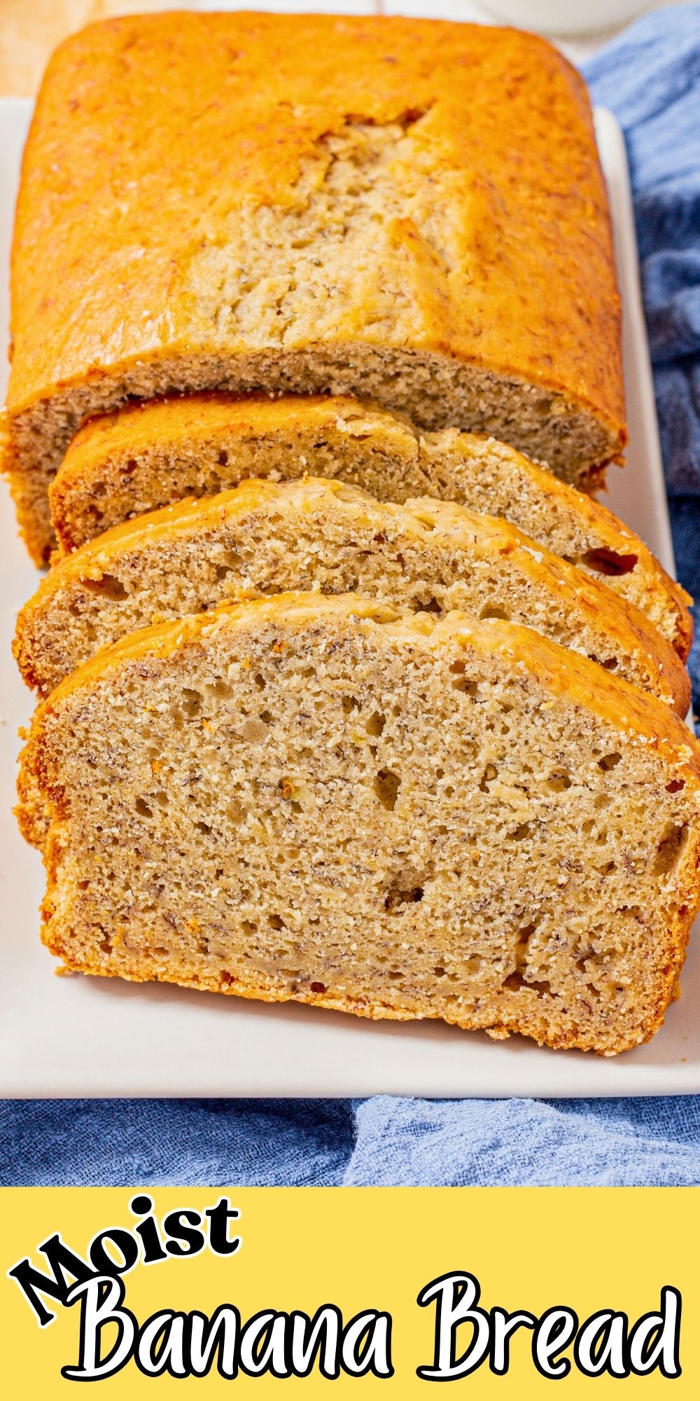 Golden loaf of banana bread on a white rectangle plate, sliced with a banana laying next to the plate.