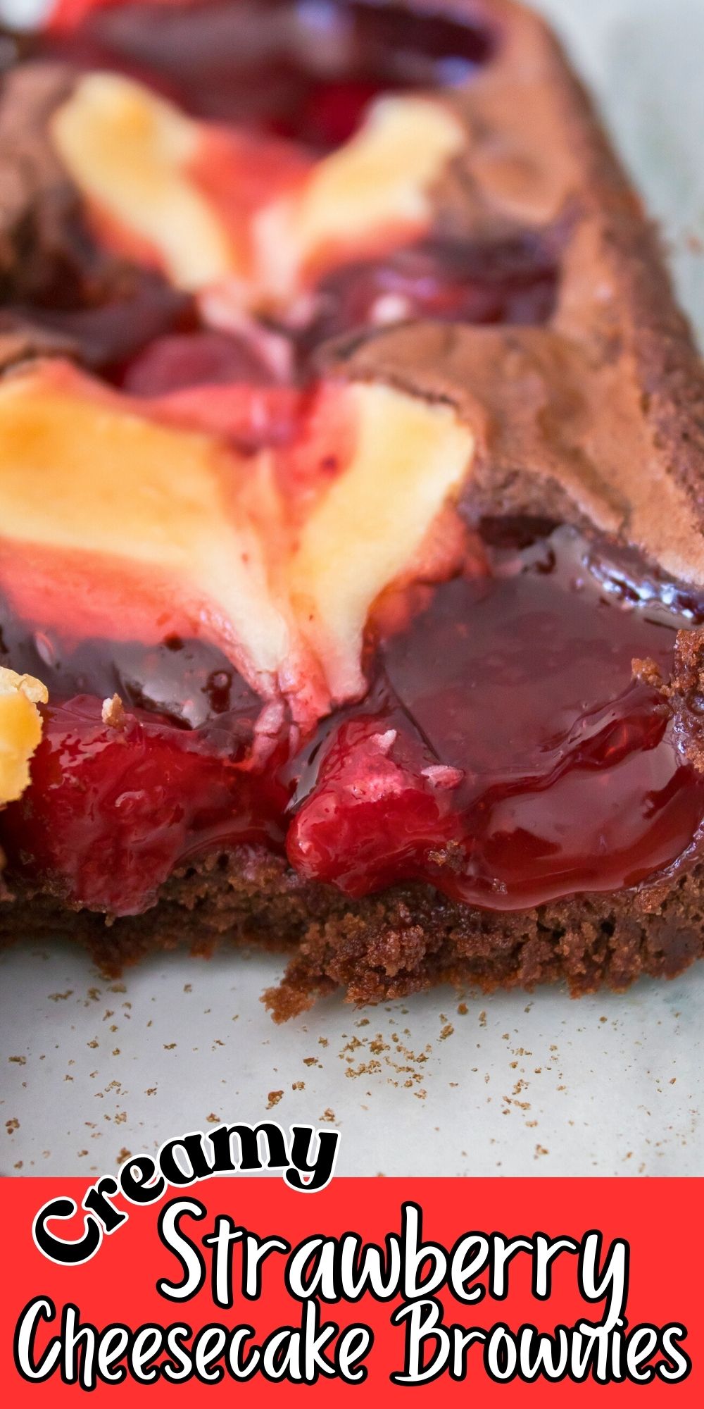 Creamy strawberry cheesecake brownies in a baking dish, cut into slices.