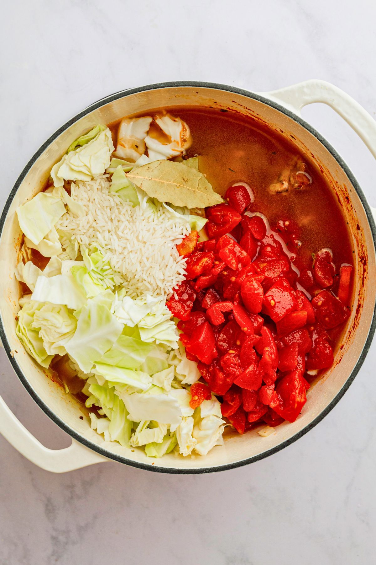 Other ingredients being added to stock pot to make cabbage roll soup.