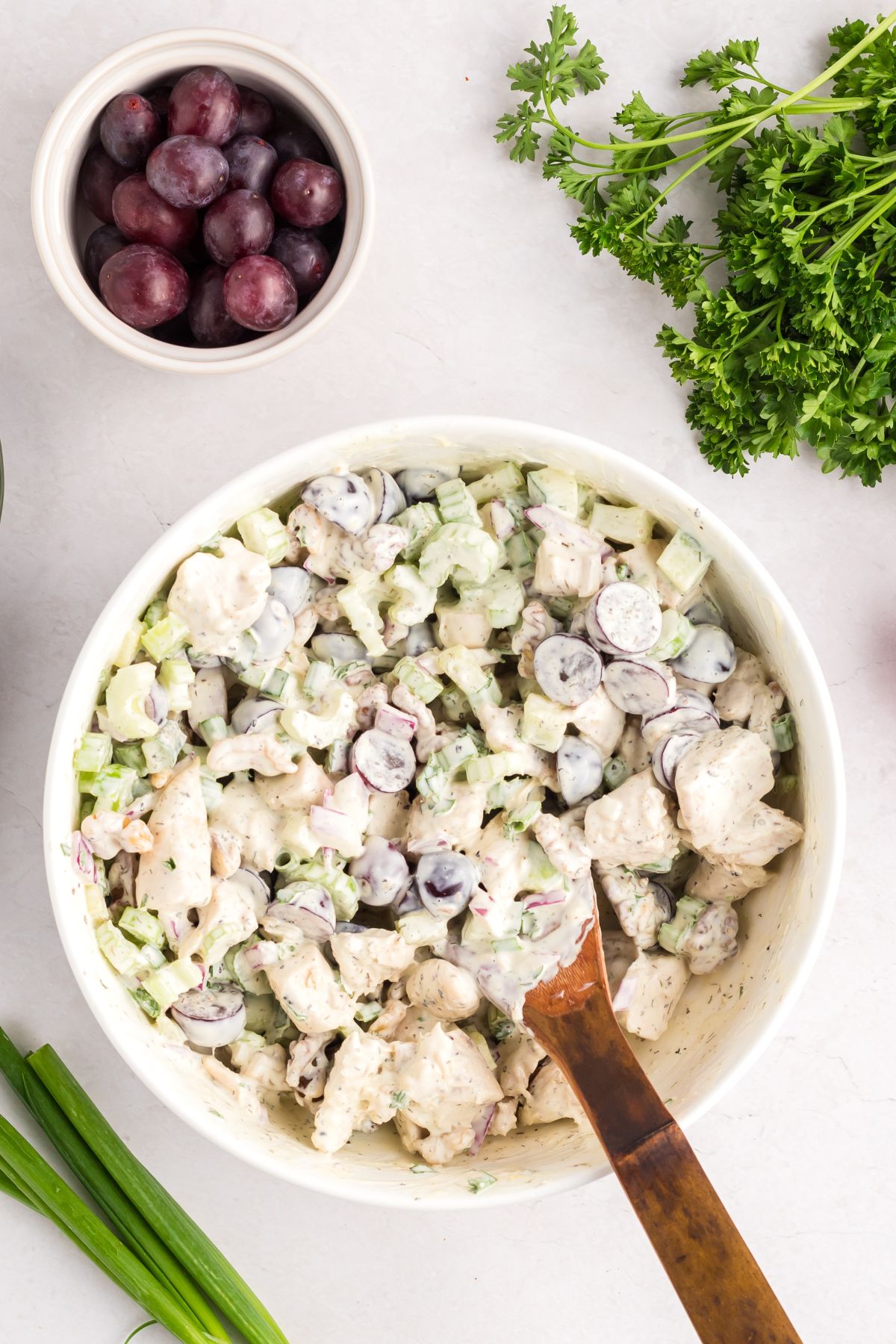 Creamy chicken salad mixed together in a bowl .