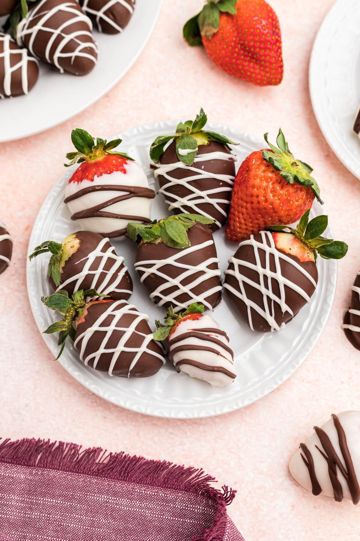 Small white appetizer plate with  strawberries added to plate. 