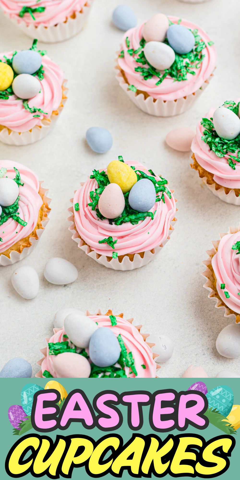 Vanilla cupcakes topped with pink frosting, green coconut, and egg shaped chocolates.