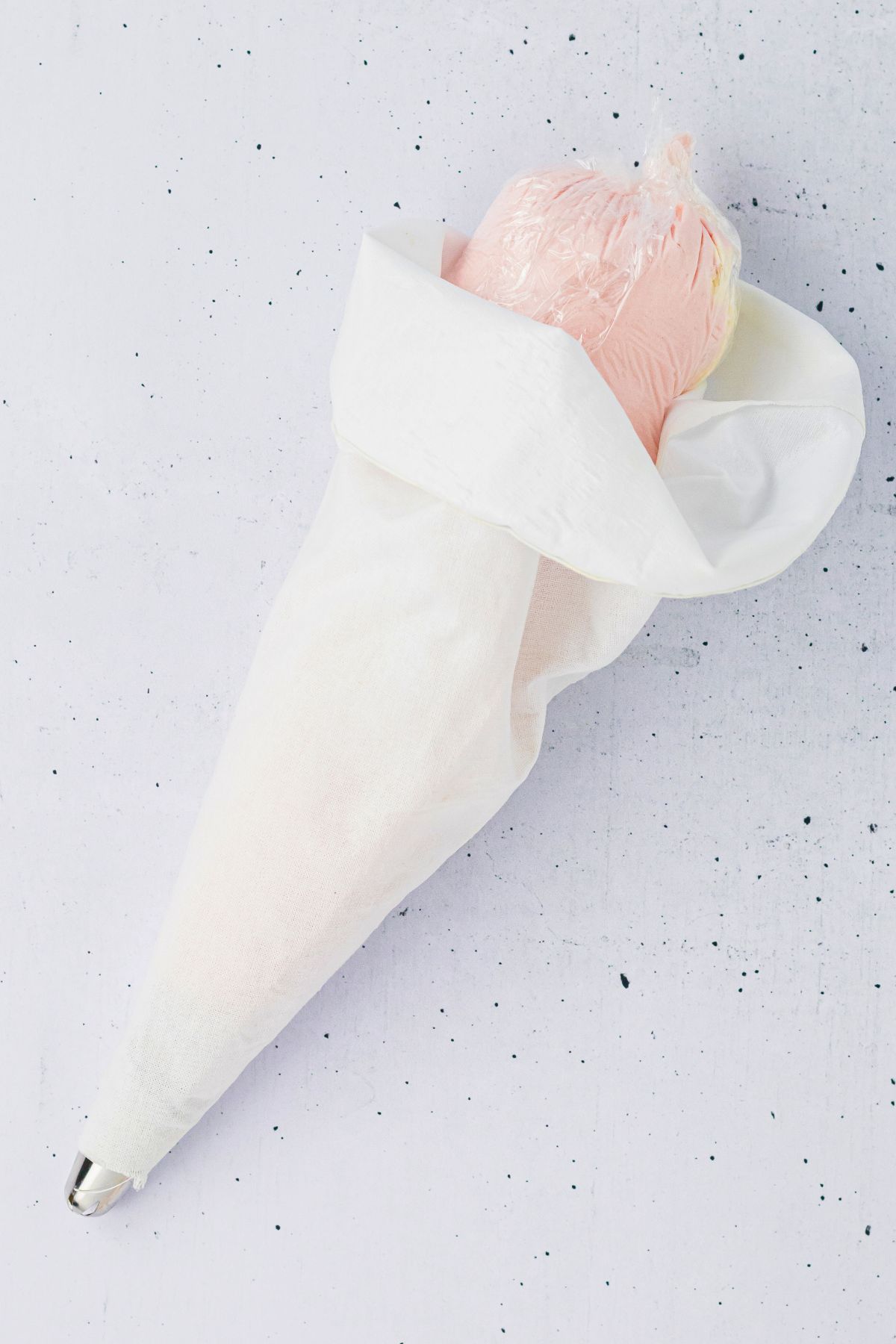 Pink and white frosting, wrapped in plastic wrap, then put into one piping bag. 