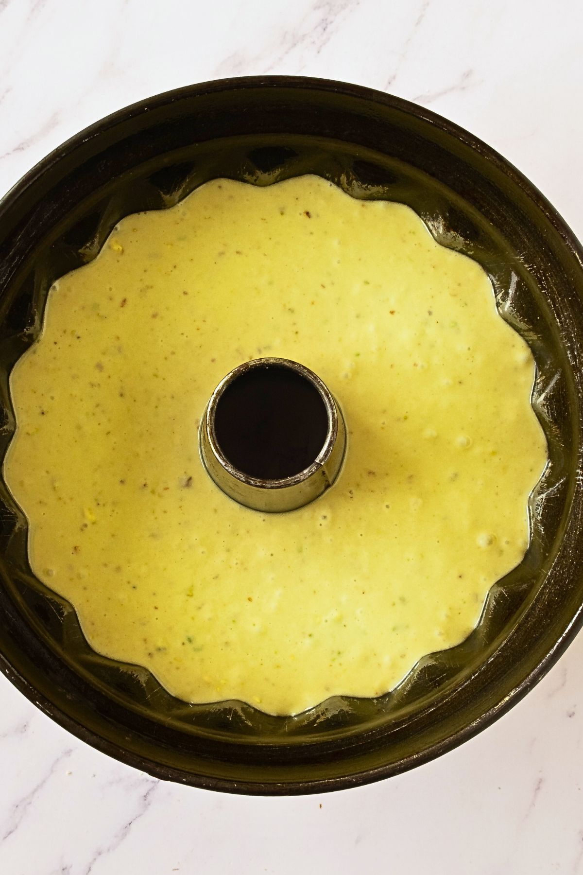 Pistachio cake mix in a Bundt cake before being baked. 