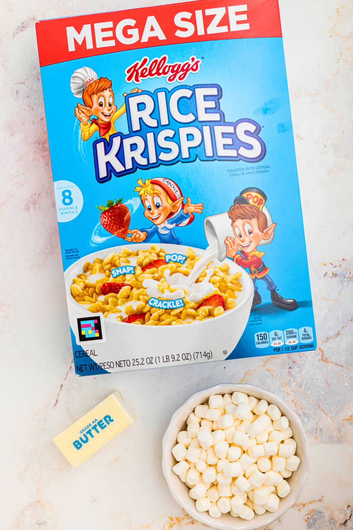 Ingredients needed to make rice krispie treats on a marble table. 