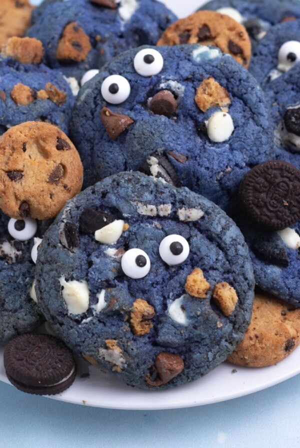 Bright blue cookie monster cookies filled with crushed cookies, chocolate and white chocolate chips.