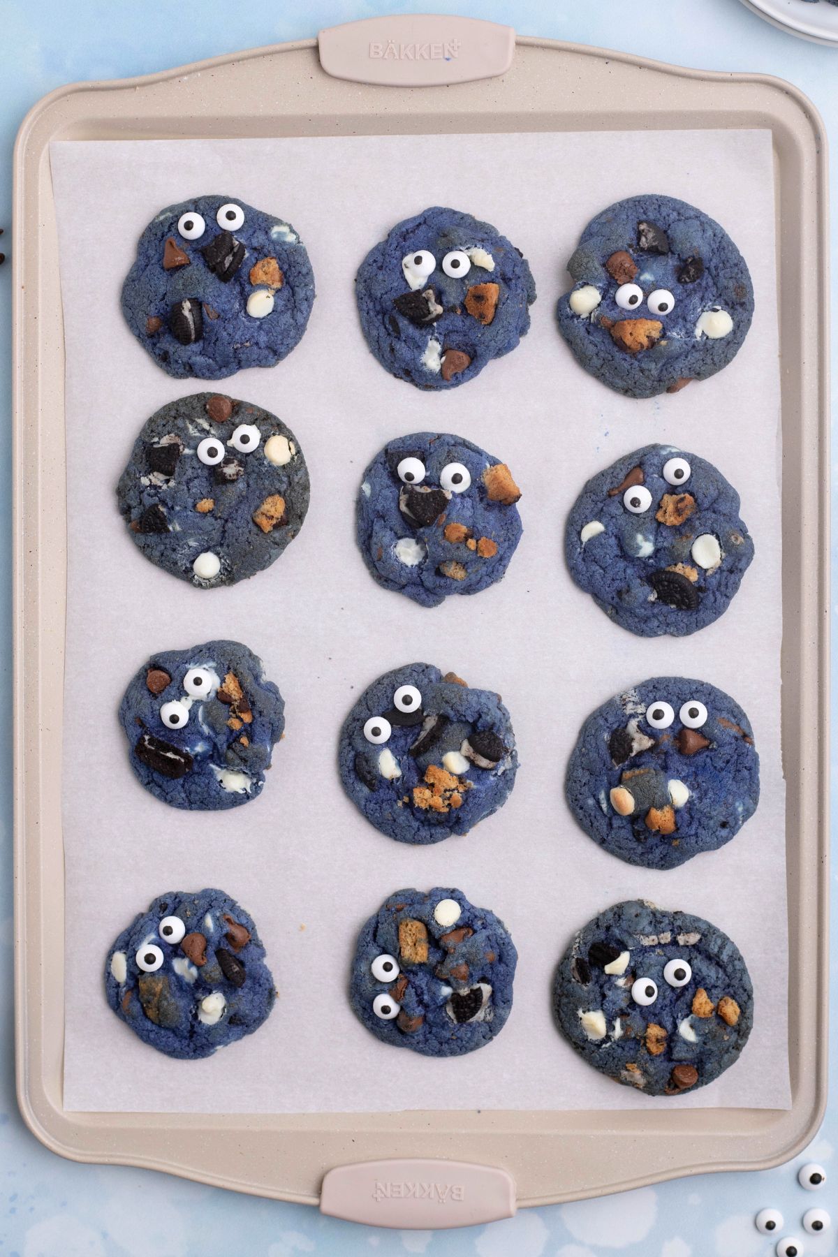 Baked cookies on a cookie sheet, lined with parchment paper. 