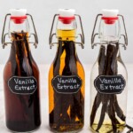 Three bottles of vanilla in different stages of sitting with pods.