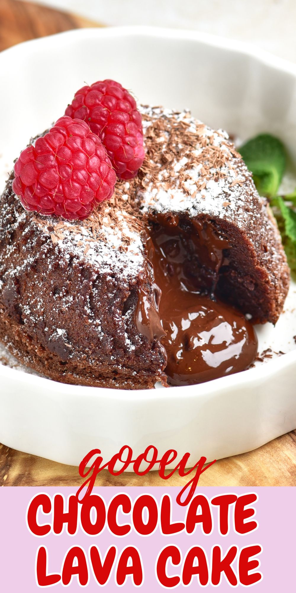 Chocolate mini cake with gooey center coming out onto a white plate.