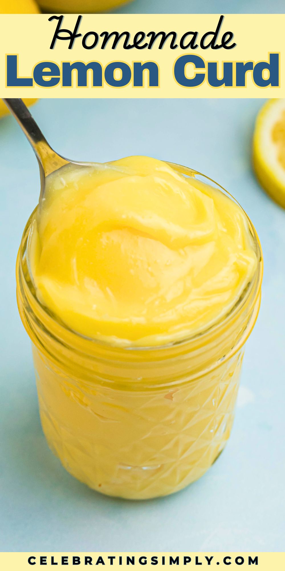 Bright yellow lemon curd in a small jar with a spoon being scooped out.