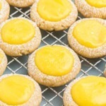 Lemon curd cookies on a wire cooling rack, after being filled with lemon curd.