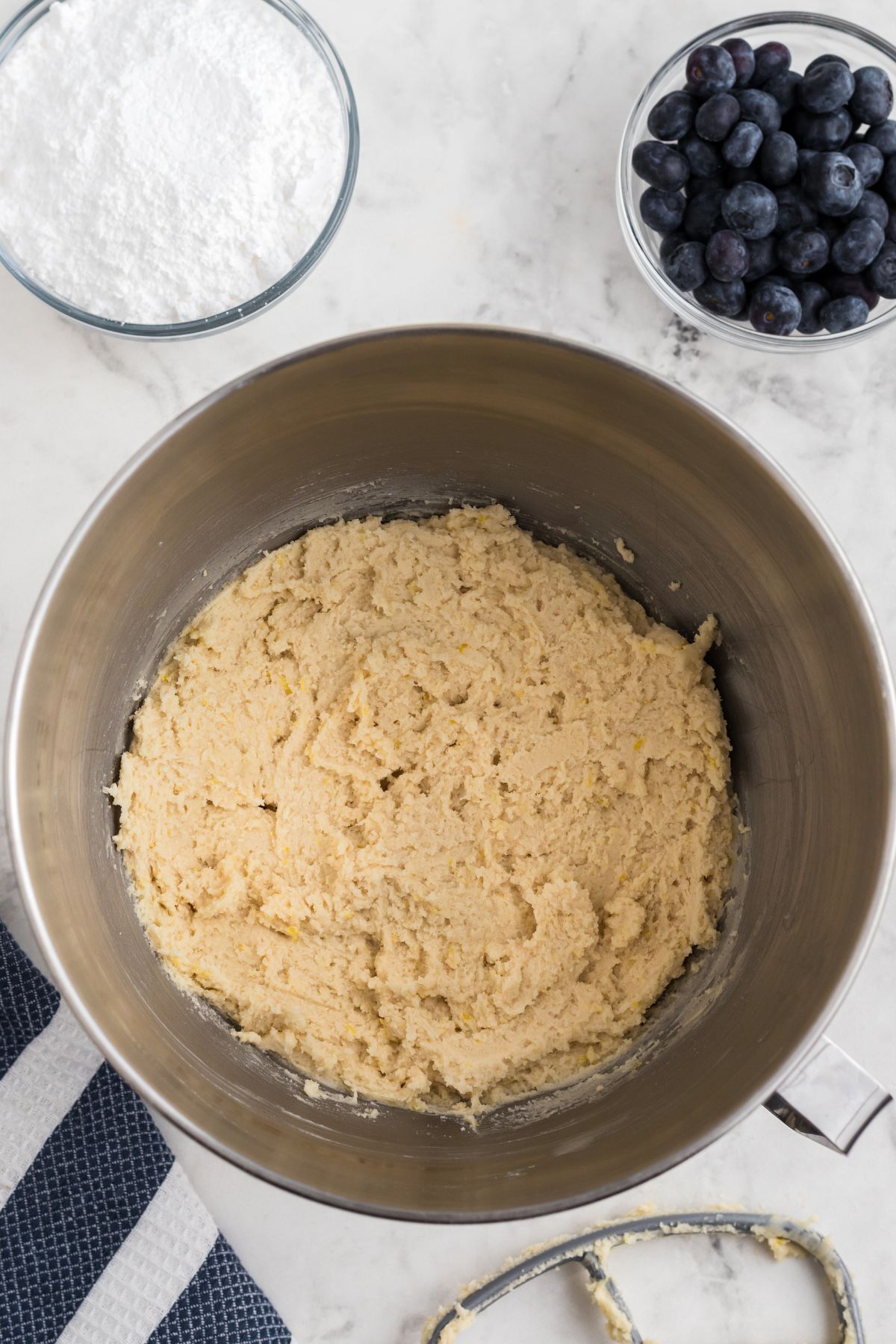 Creamy cookie dough mixed together in a silver bowl. 