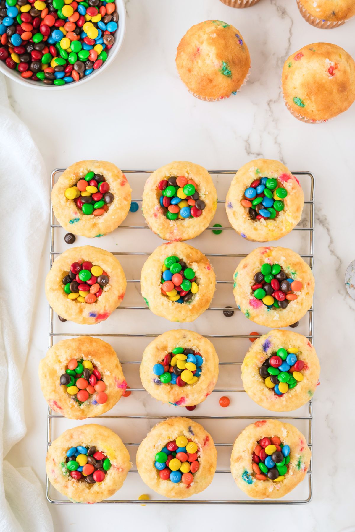 Vanilla cupcakes with the center scooped out and filled with min M and M's. 